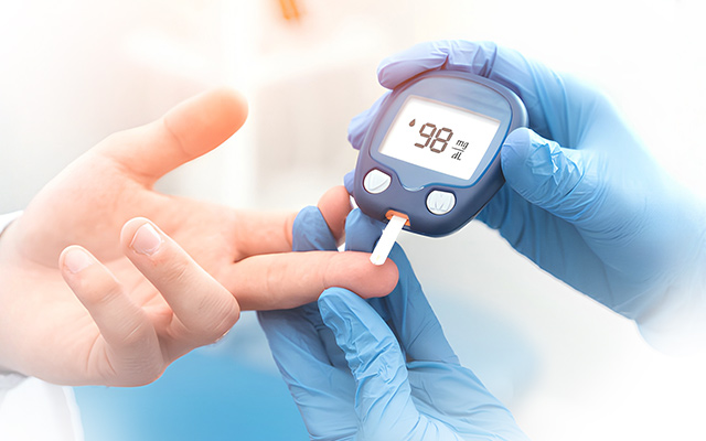 doctor checking diabetes using glucometer