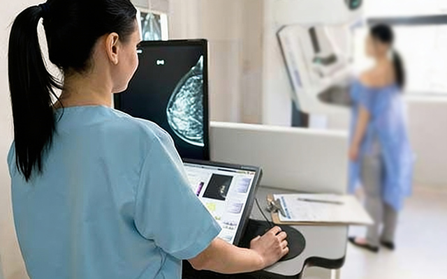 Healthcare professional reviewing a mammogram scan for breast cancer screening and early detection at a diagnostic centre.