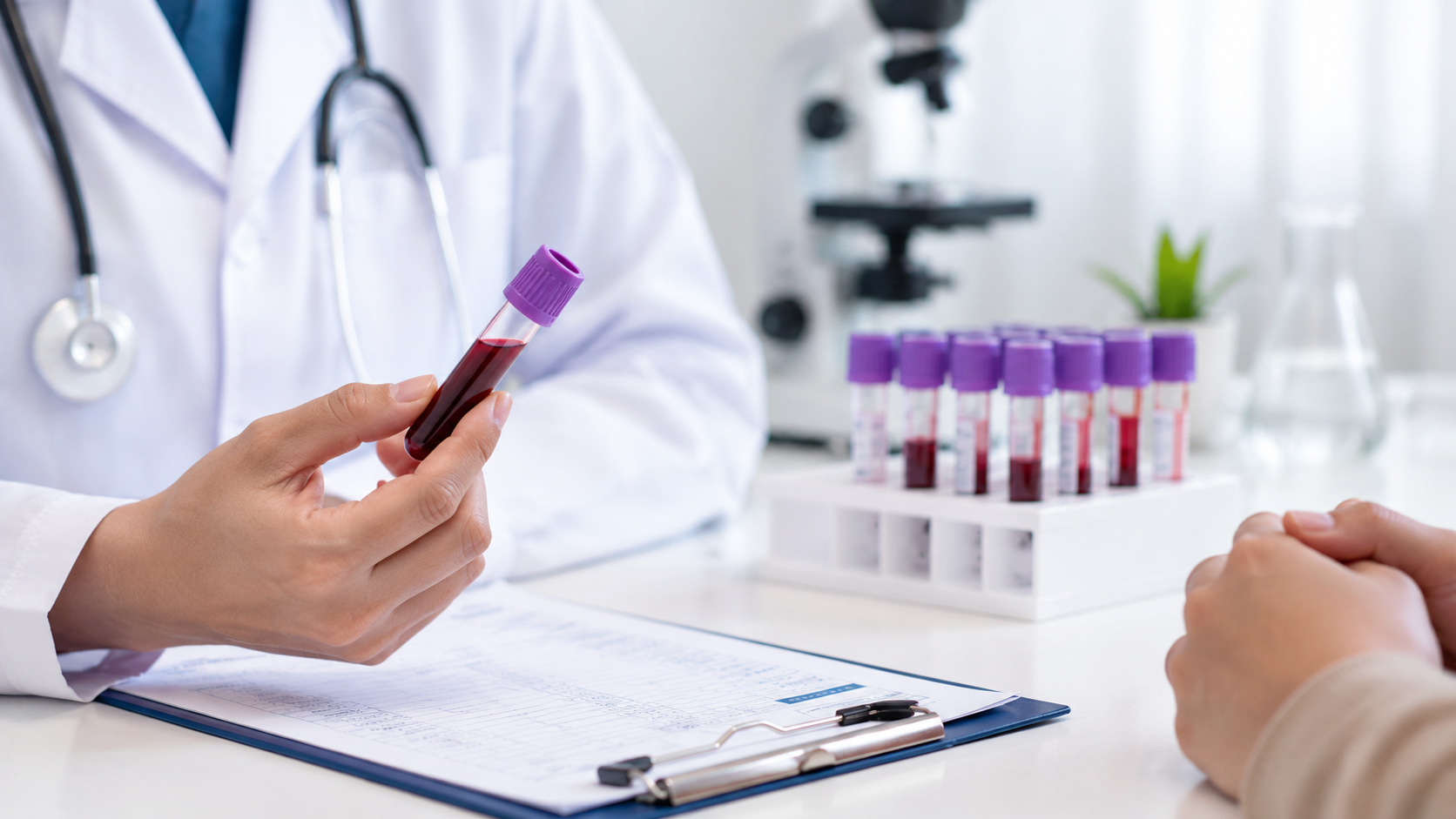 Doctor reviewing a blood sample and discussing CBC test results with a patient during a medical consultation in a laboratory setting.